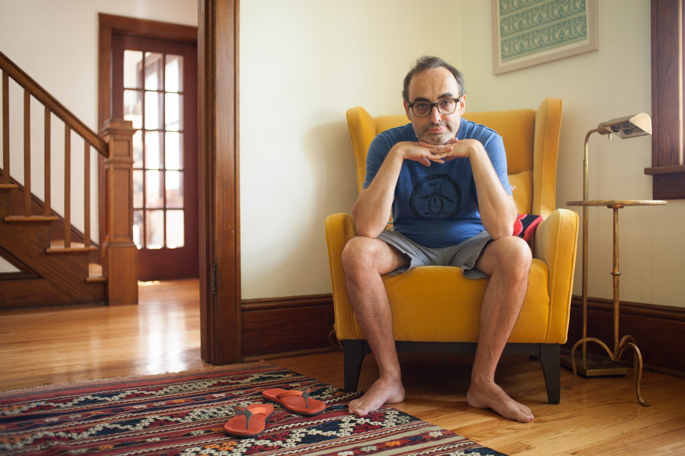 Portrait of eccentric writer Gary Shteyngart at home on chair for German translation of book LIttle Failure Red Hook NY