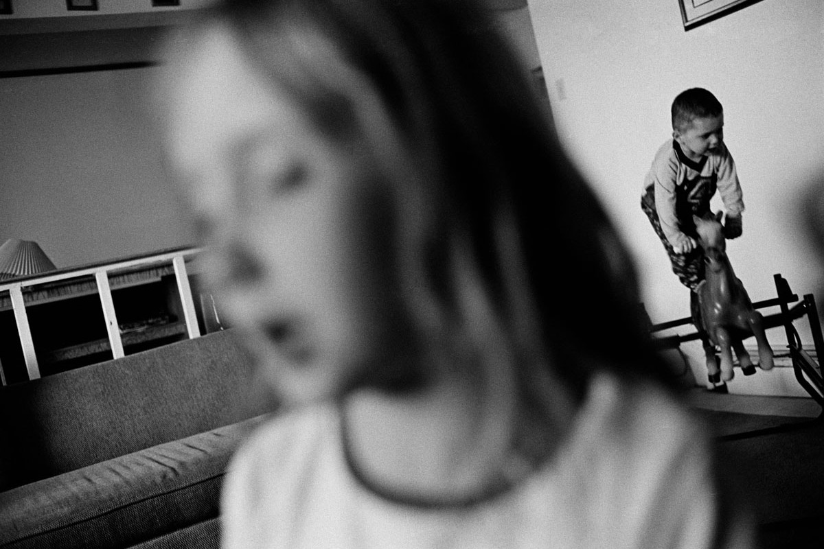 Black and White Picture of Girl Singing & Boy Riding Rocking Horse at Home Utah