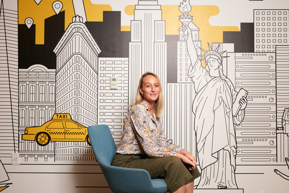 Creative business portraits of young female executive with NYC mural